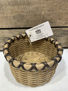 Catch-all basket, perfect for counter tops, display, or gifting. Approximate size - 6" w x 4" h, round, with dark brown accent. Locally made in the Hudson Valley by master basket weaver, Mary Ann Williams.
