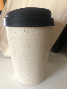 This keep cup is made with a slightly tapered shape to fit comfortably in most car cup holders. keep in mind, this cup will get warm with the heat of your beverage.  This item is hand made so no two pieces are exactly alike. please expect slight variations in size, shape and finish. it is made using food safe clay and glazes.  approximately 4.5” tall + the height of the lid, holds approximately 10 oz